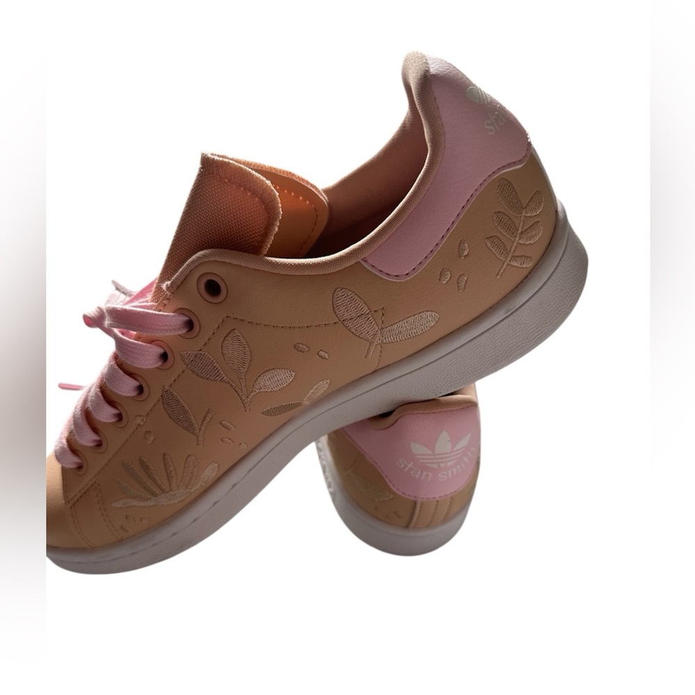 Melon-colored adidas shoes with pink